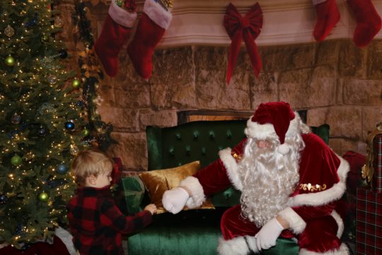 santa fist bumping a kid