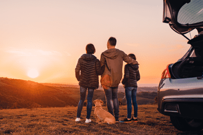 People at car during sunset.