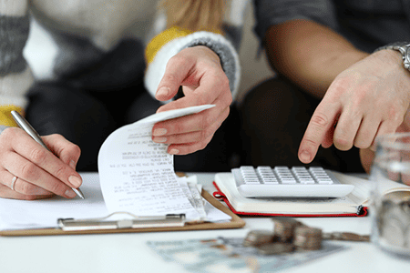 a couple going over their monthly expenses