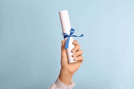 a hand holding a diploma