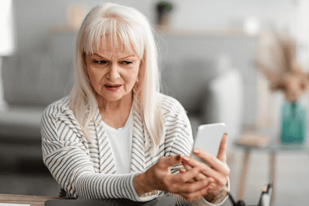 a woman looking confusedly at her phone